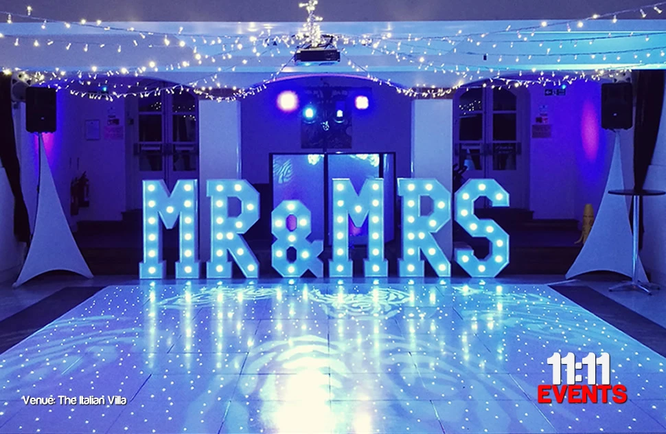 Wedding venue the italian villa, Poole with DJ equipment, 4ft high mr&mrs light up letters and a white starlit LED dance floor with a blue glow to the picture from nearby mood up lights