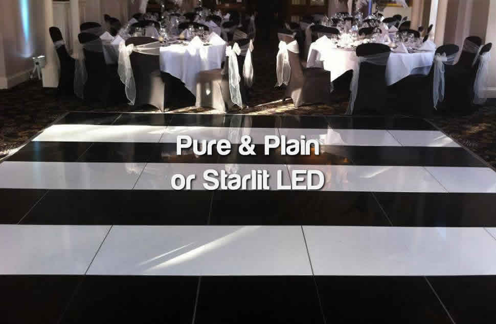 A photo of a striped dance floor pattern using plain black and white panels in front of black and white tables
