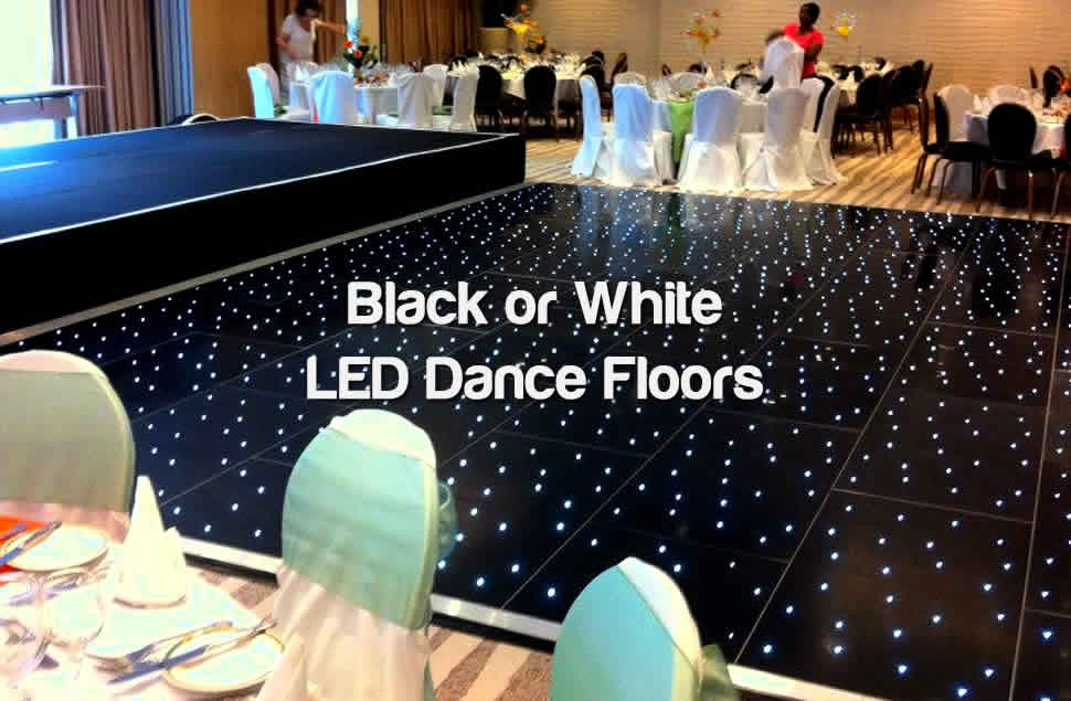 Photo of a black LED starlit dance floor (20x20ft in size) with a clean black stage to the left and tables dressed in black or white to the top