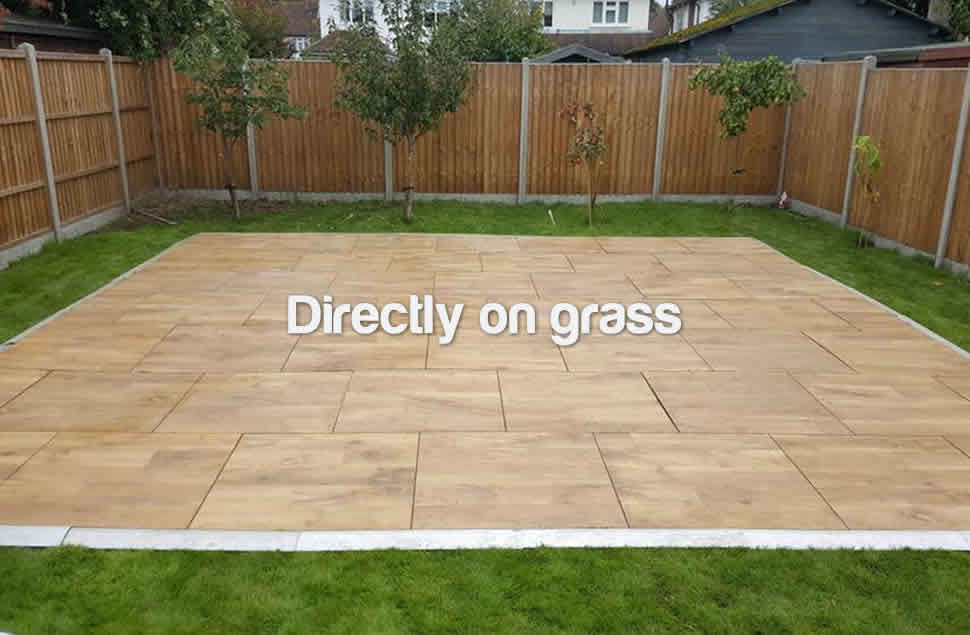 Photo of a large 21x12ft oak effect outdoor dance floor for a private garden party on a green lawn with brown fencing surrounding the dance floor