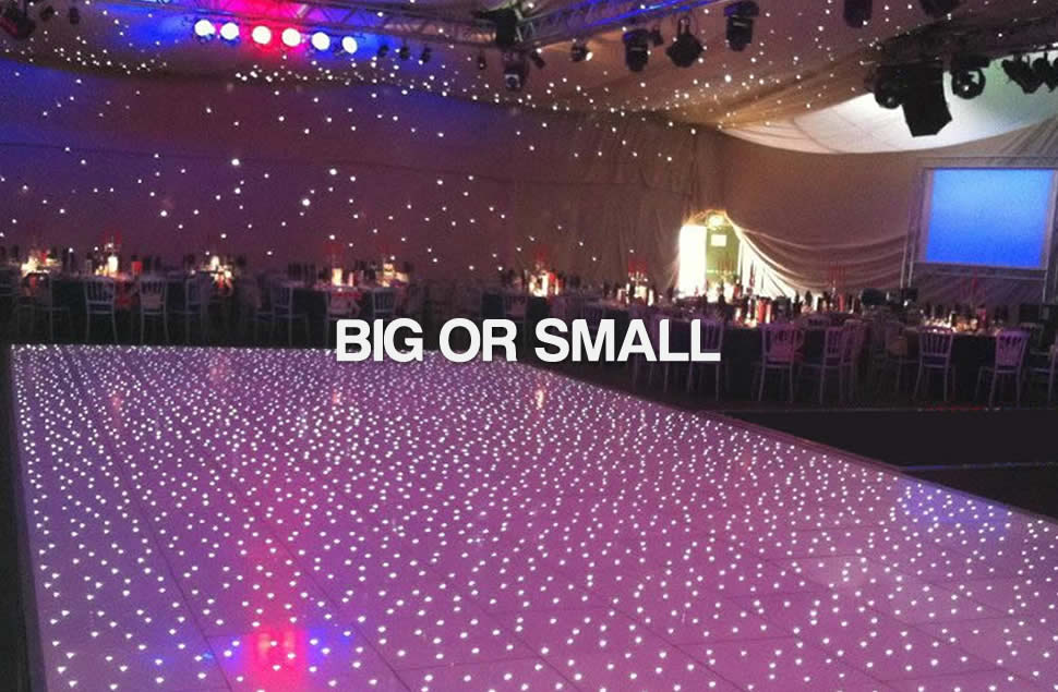 Photo of a large white LED starlit dance floor installed for a big event with the floor soaking up the pink lights around