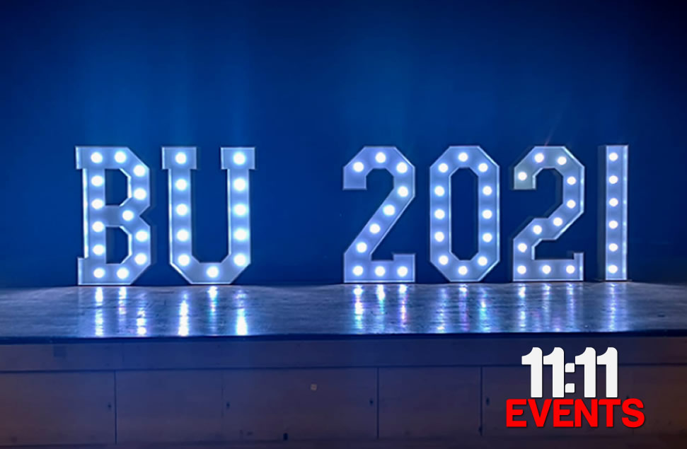 Photo of light up letters and year numbers in white BU 2021 with the lamps set to cool white for Bournemouth university graduation