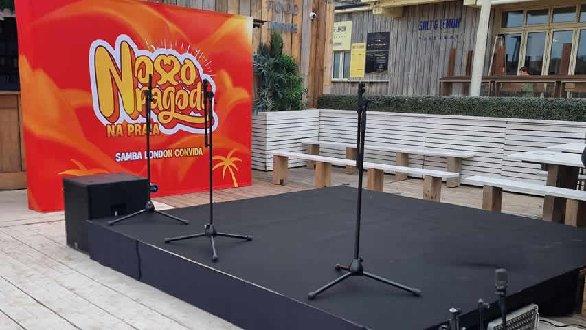 Beach stage with branding, black carpet and finished skirt in Bournemouth