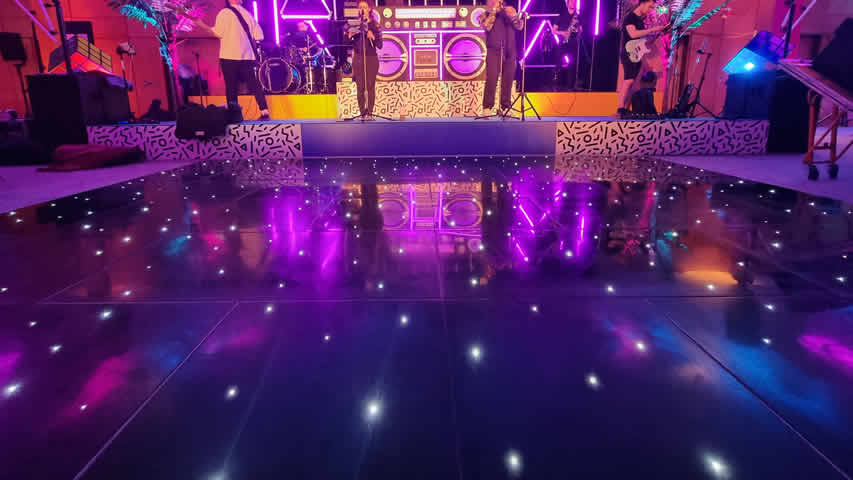 Black starlit dance floor at an 80s corporate party