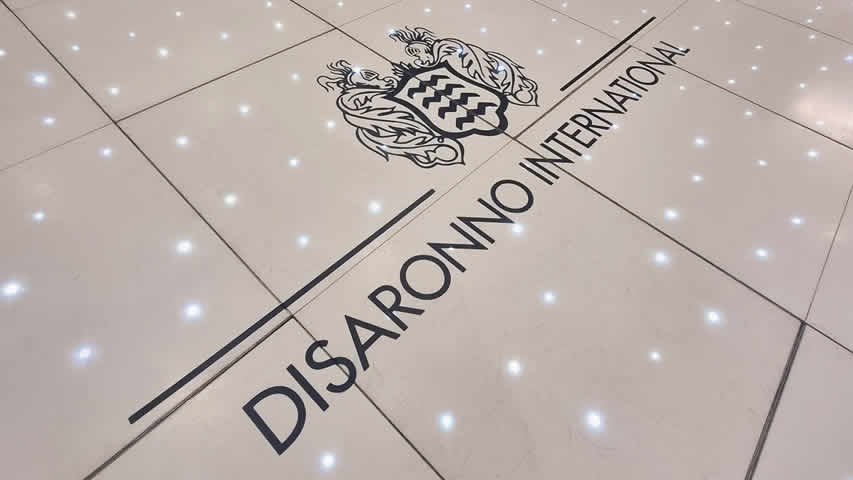 Dance floor sticker with corporate monogram branding on a white starlit dance floor at Nici Bournemouth
