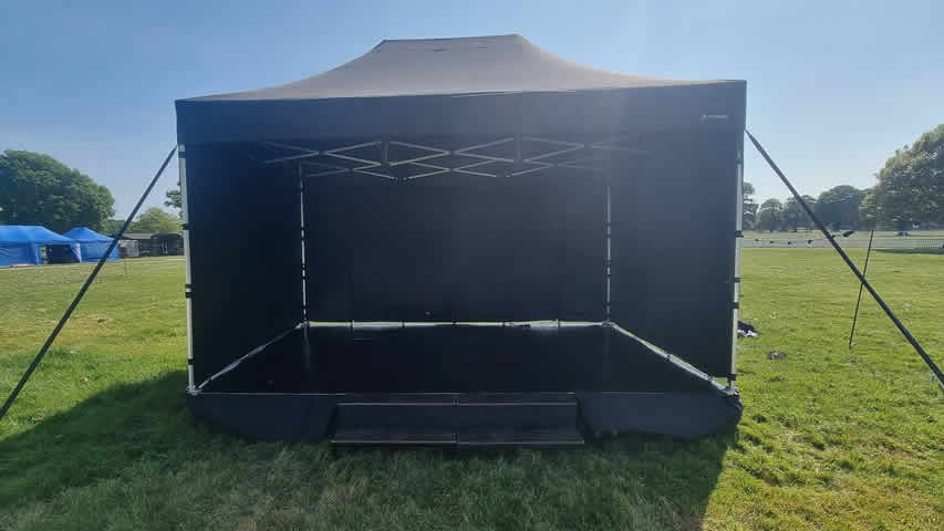 4.5x3m stage covered with a black roof in New Forest