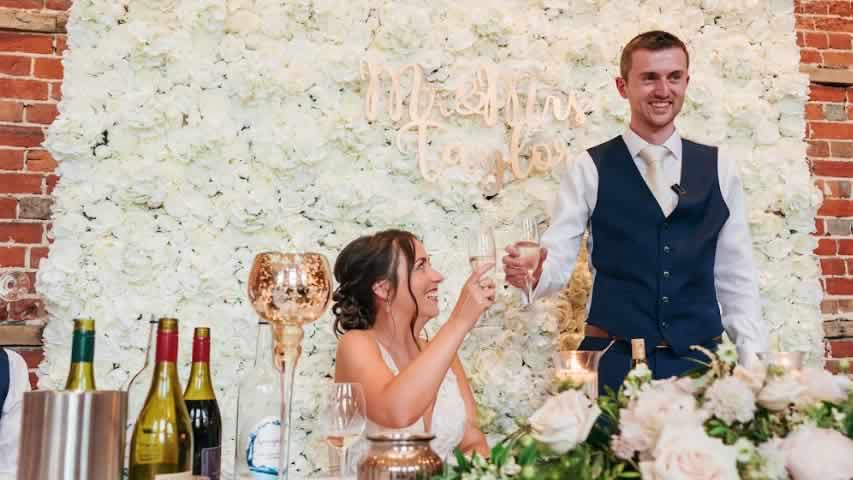 Highcliffe Castle Wedding with Ivory White Flower wall as a beautiful backdrop to wedding speeches